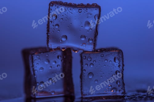 Preview: Ice cubes on table against purple background