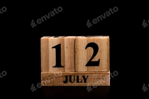 Preview: wooden calendar 12 July word on black background with copy space , selective focus at the calendar