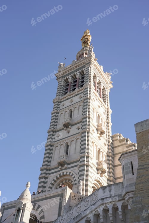 Preview: Low-angle shot of the cathedral of Notre Dame de lagarde in Marseille, France against the blue sky