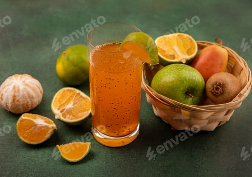 Preview: top view of healthy and fresh fruits such as apples pear kiwi on a bucket with fresh fruit juice in