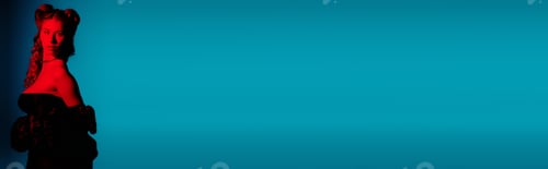 Preview: Stylish young woman posing confidently against a vibrant blue background