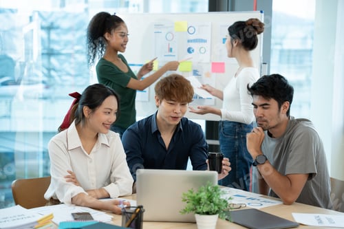 Preview: Business people discussing documents and ideas at meeting