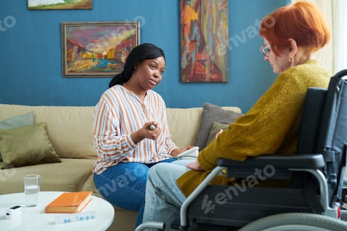 Preview: Nurse checking blood pressure of senior woman