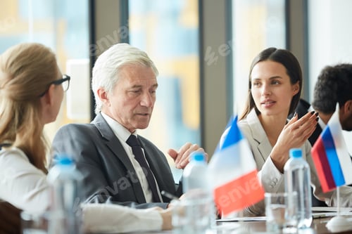 Preview: Thoughtful senior politician talking to colleagues