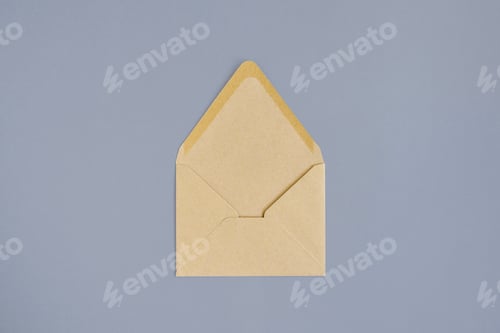 Preview: Open empty envelope made of craft paper on gray background. Close-up. Top view. Copy space.