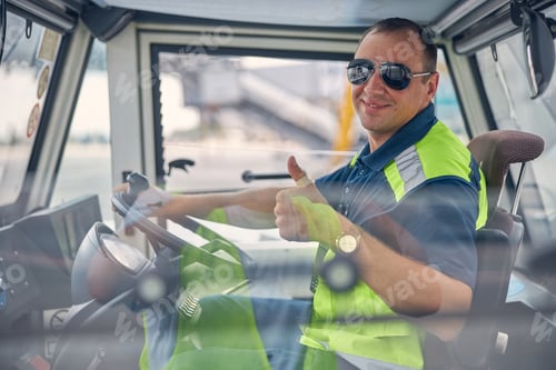 Preview: Smiling man in a car posing for the camera