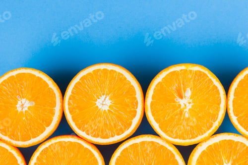 Preview: Cut Halves Of Juicy Orange On Blue Background. Orange Fruit, Citrus Minimal Concept. Creative