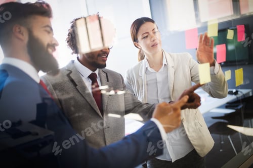 Preview: Group of happy business people working in a meeting at office
