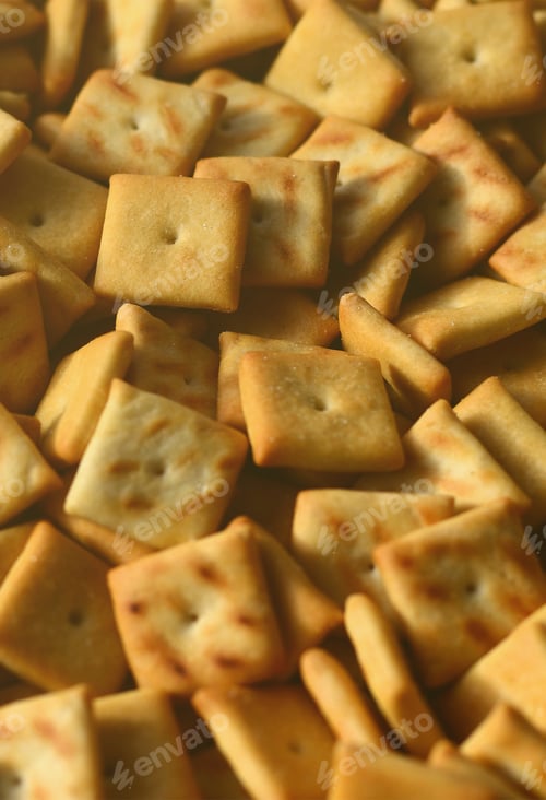 Preview: Background texture of small edible squares baked from dough and sprinkled with salt