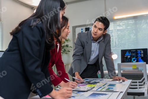 Preview: Business team analyzing financial charts and graphs in modern office