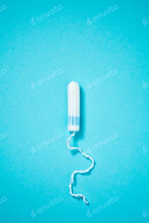 Preview: Medical female tampon on a blue background with copy space