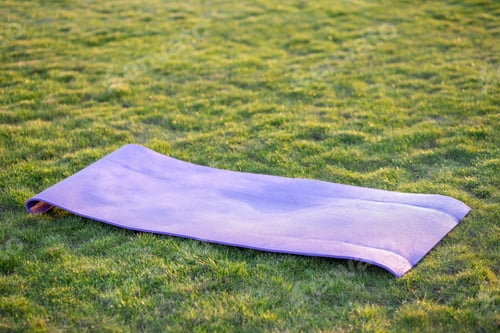 Preview: Blue mat for yoga or fitness on green grass lawn outdoors