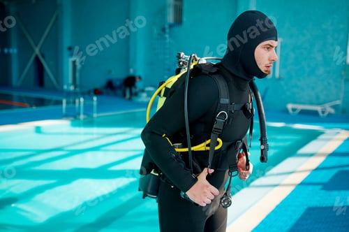 Preview: Male diver in scuba suit prepares for dive, diving