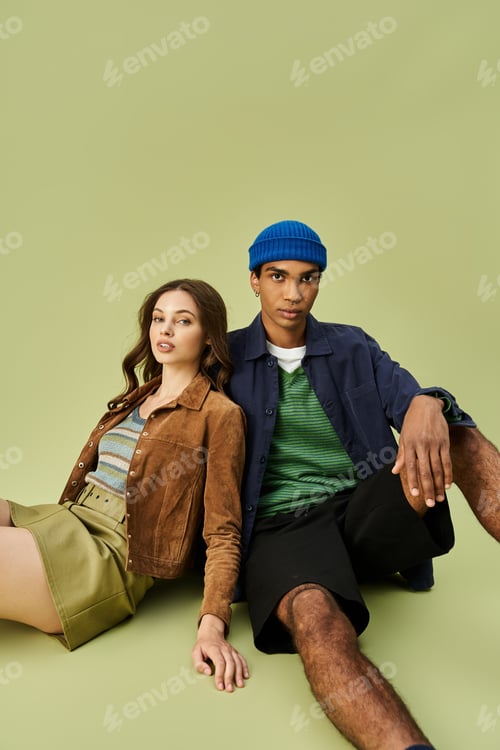 Preview: A trendy couple in stylish autumn outfits relax together in a cozy indoor setting