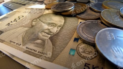 Preview: Five hundred Indian Rupee note with Mahatma Gandhi's face, surrounded by different coins
