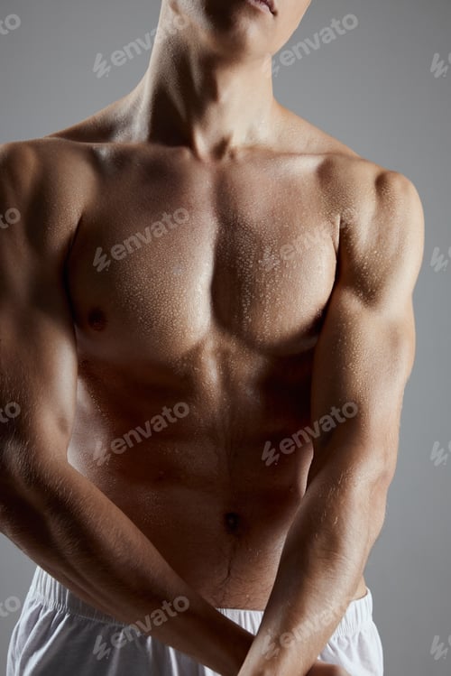 Preview: athlete with muscular body in white shorts joined hands on gray background cropped view