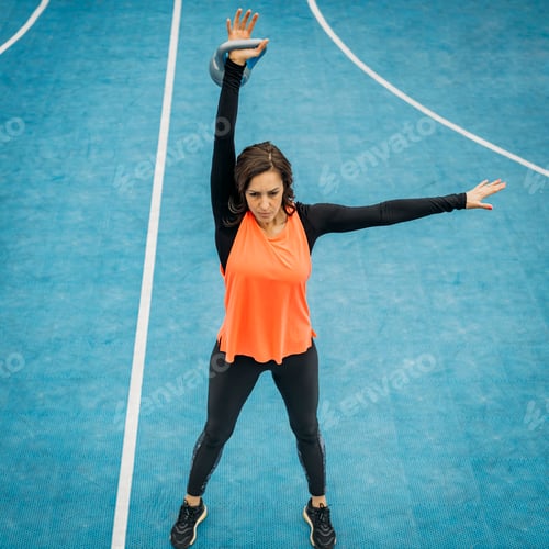 Preview: Fit Young Woman Swinging Kettle Bell, Outdoors