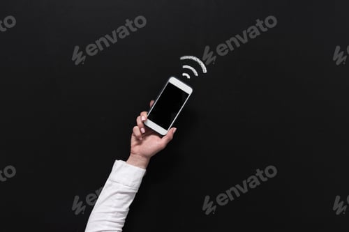 Preview: hand of woman holding smartphone with blank screen isolated on black