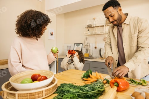 Preview: Family Preparing Fresh Food Together in Kitchen