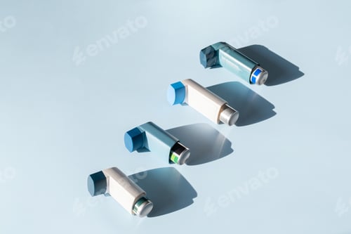 Preview: Asthma Inhalers Aligned on Serene Blue Backdrop. Medical Concept