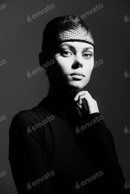 Preview: Striking Woman with Netting and Dramatic Lighting