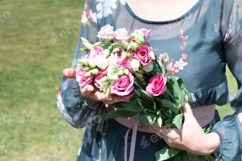 Preview: middle-aged woman with a bouquet of pink eustomas a gift for mother's day,spring