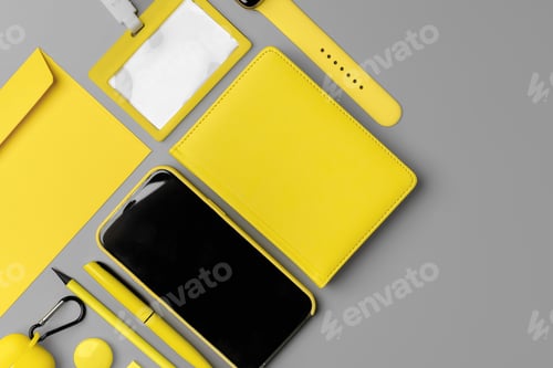 Preview: Yellow notepad with smartphone, smartwatch and earphones on gray background