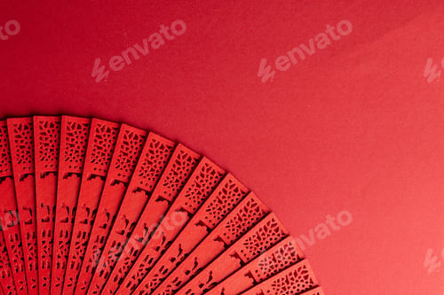 Preview: Composition of traditional chinese fan on red background