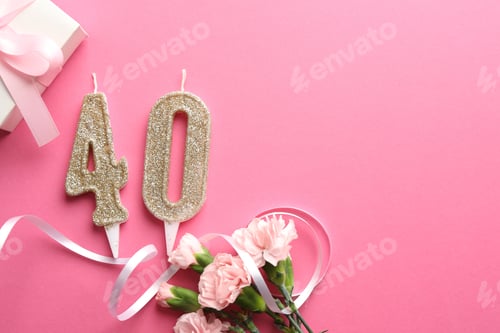 Preview: 40th birthday. Number shaped candles, gift and flowers on pink background, flat lay. Space for text