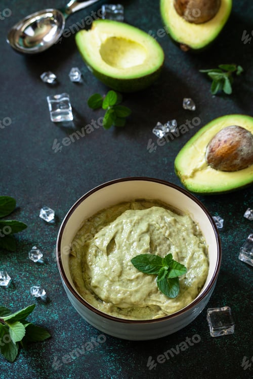 Preview: Homemade avocado fruit ice cream, summer tropical fruit sorbet on a stone table.