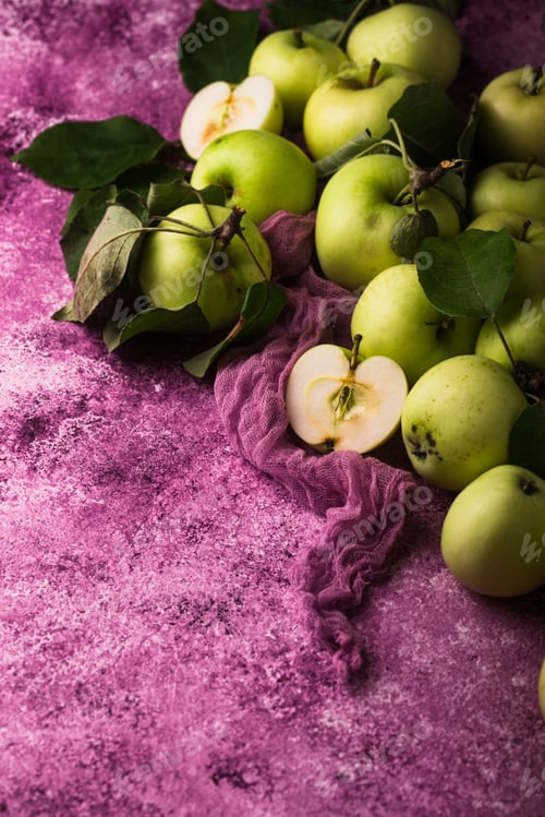 Preview: Fresh ripe green apple in purple background.
