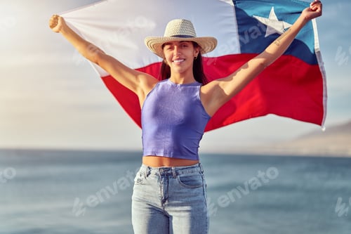 Preview: latin woman holding a flag of Chile outdoors against blue sky