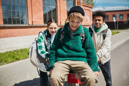 Preview: Group of teenagers having fun outdoors