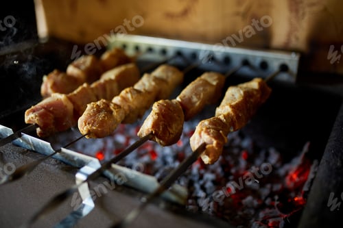 Preview: Summer Barbecue at Home Featuring Kebabs Grilling in a Backyard Grill