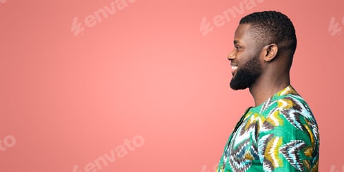 Preview: Side view of black smiling guy looking at free space