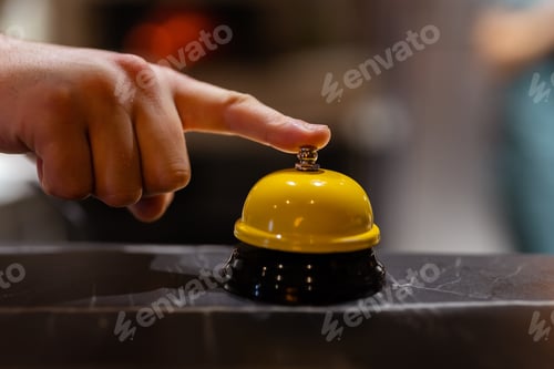 Preview: Finger rings the Service bell on blurred background