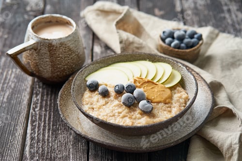 Preview: Oatmeal, healthy porridge in large bowl with fruits and berry for breakfast