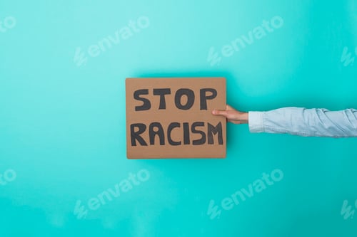 Preview: Crop anonymous person showing banner with stop racism text