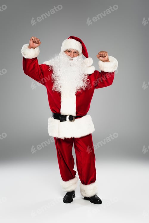 Preview: Excited santa claus showing yes gesture on grey background