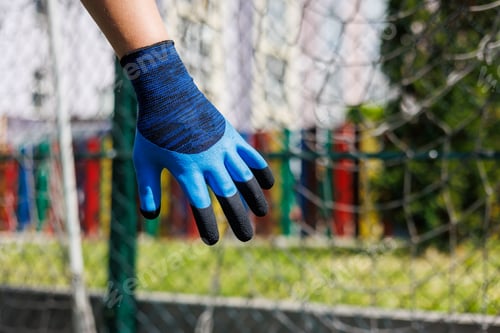 Preview: Close-up of male hands in construction gloves. Gloves for performing heavy dirty work
