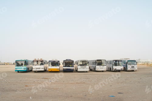 Preview: Tour buses parked in dirt lot