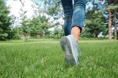 Preview: Female legs walking on grass