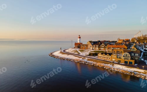 Preview: Lighthouse of Urk during winter with snow in the Netherlands. Dutch village in winter with snow