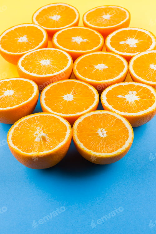 Preview: Cut Halves Of Juicy Orange On Yellow Blue Background. Orange Fruit, Citrus Minimal Concept