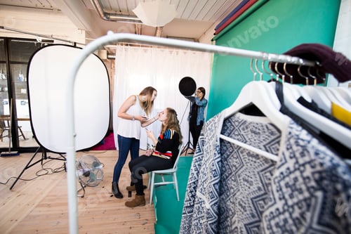 Preview: Behindthescenes at a fashion photo shoot with stylists perfecting the model's look