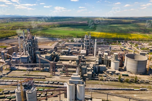 Preview: Aerial view of cement factory with high concrete structure and tower crane
