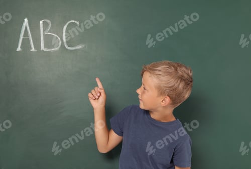 Preview: Little school child near chalkboard with letters ABC