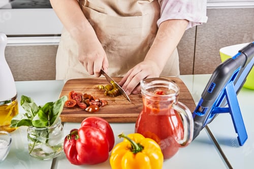 Preview: Teenager prepare spaghetti bolognese from an online textbook and watches digital recipe