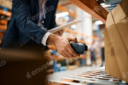 Preview: Close up of warehouse inspector scanning packages at storage compartment.