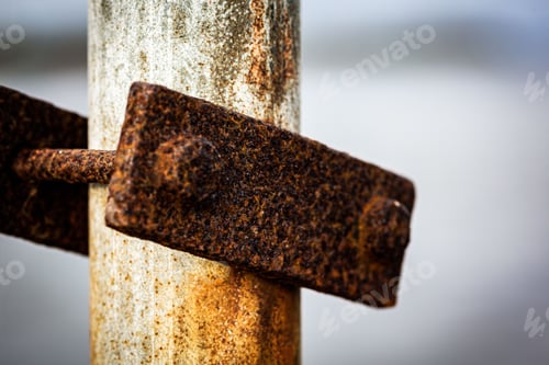 Preview: an old rusted steel object is hanging on a pole